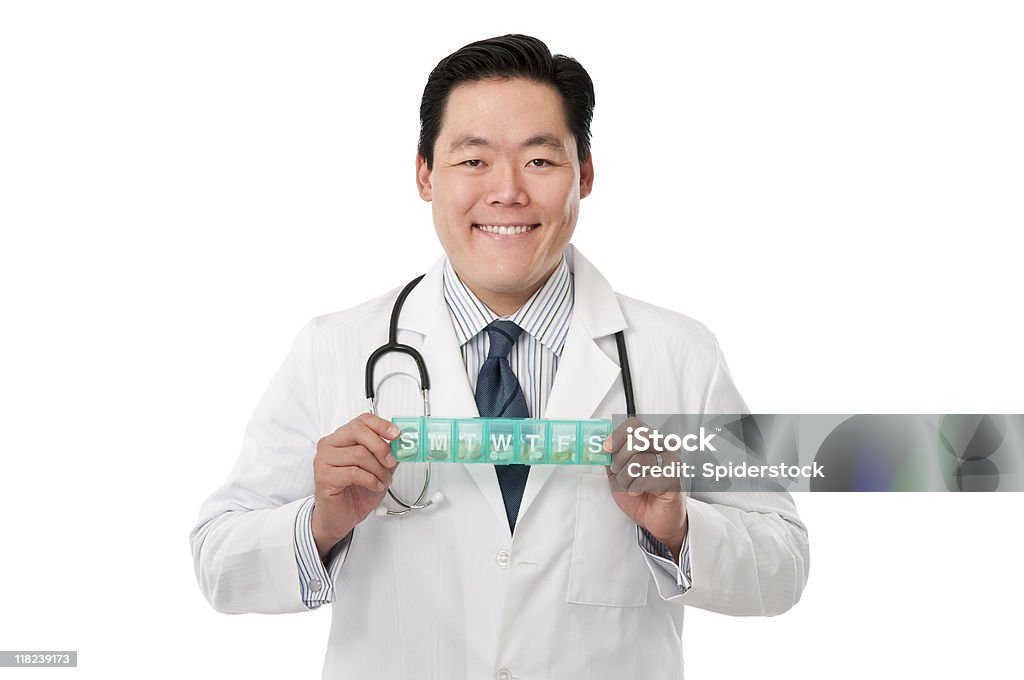 Young Asian Doctor With Pill Box Young smiling male Asian Doctor holding pill box. 30-39 Years Stock Photo