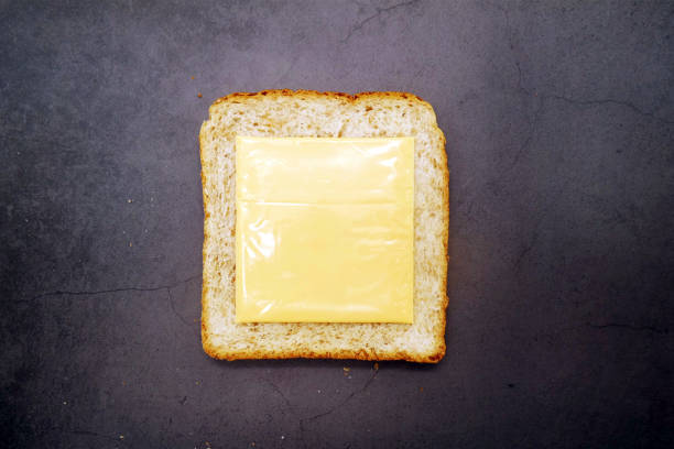Yellow Cheddar Cheese With Healthy Brown Bread On Concrete Background