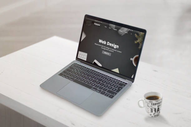 istock Web design studio concept web page on laptop. Clean scene with cup of coffee beside. Web development or design studio concept. 1182398947