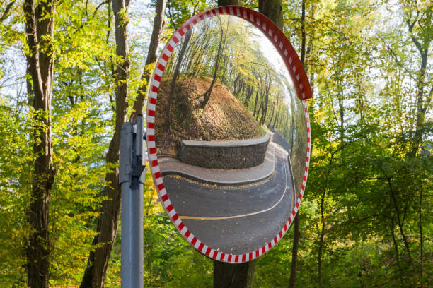 istock Convex spherical traffic mirror mounted on a winding forest road 1182399072