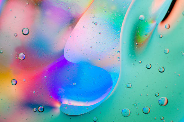 istock Iridescent abstract macro background of moving oil drops 1182399954