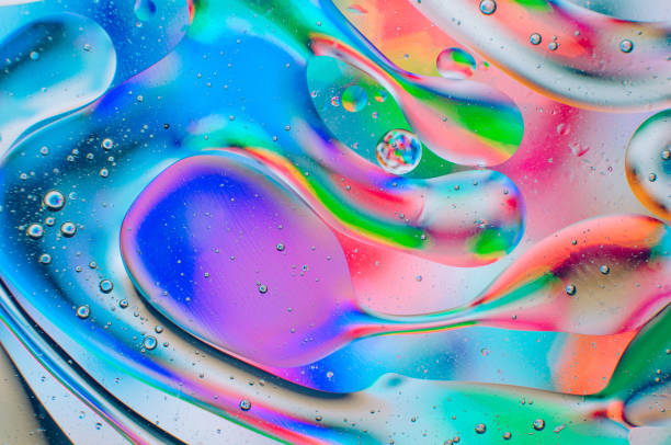 istock Iridescent abstract macro background of moving oil drops 1182399990