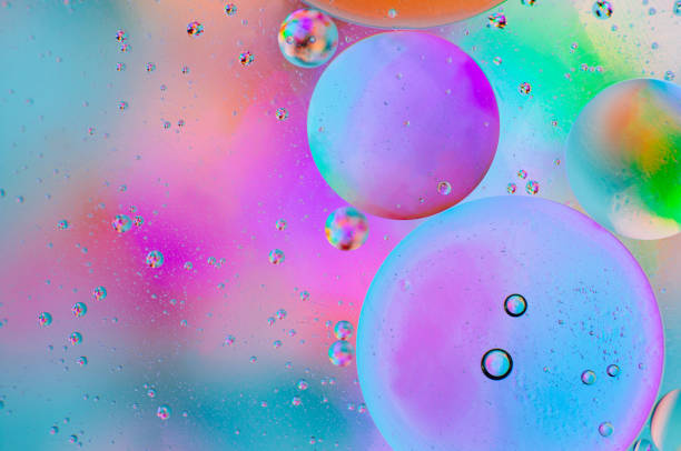 istock Iridescent abstract macro background of moving oil drops 1182399994