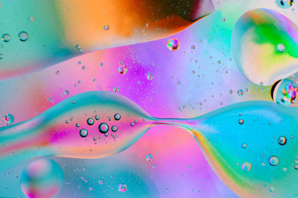 istock Iridescent abstract macro background of moving oil drops 1182399996