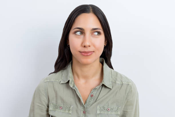 istock Young woman with happy expression looking to the side 1182400099
