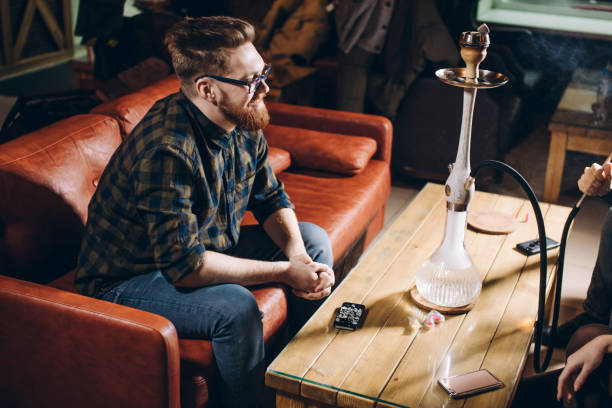 istock cherful ginger man in stylish clothes sitting on the sofa 1182401433