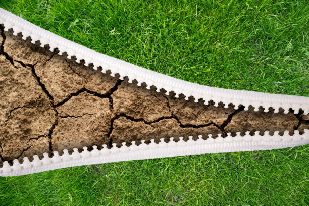 istock open zipper green grass and dry land 1182404270