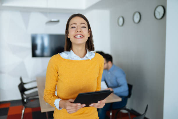istock Young businesswoman using digital tablet in the office 1182404297
