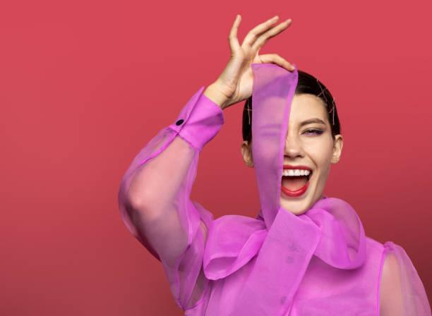 istock girl in studio covers her left eye with blouse tie 1182404737