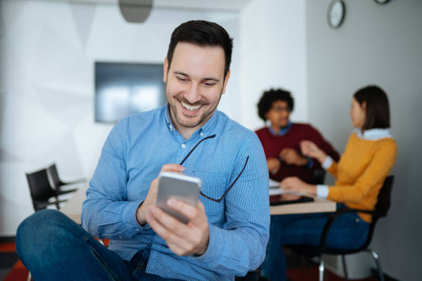 istock Young businessman checking text messages on his smart phone 1182405689