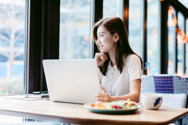 istock Asian woman working laptop at cafe. 1182409440