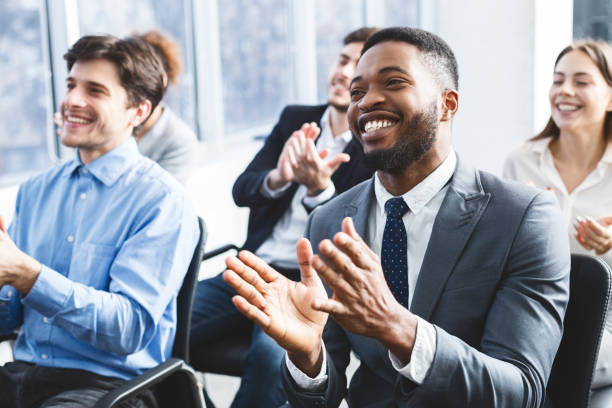 istock Happy businessmen applauding good presentation in office 1182411089
