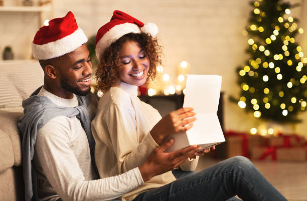 istock Happy afro couple opening Christmas gift box 1182411944