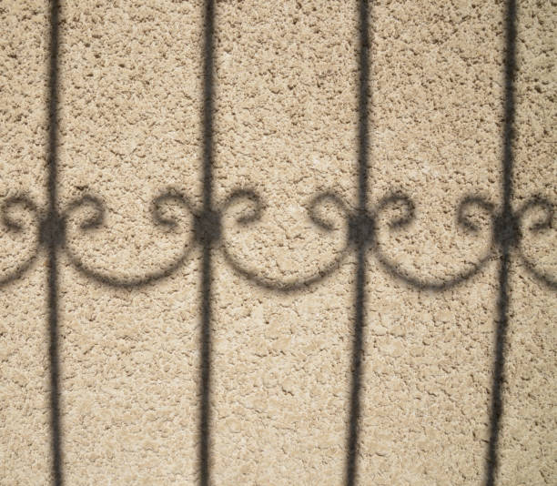 istock shadow of a fence 1182411970