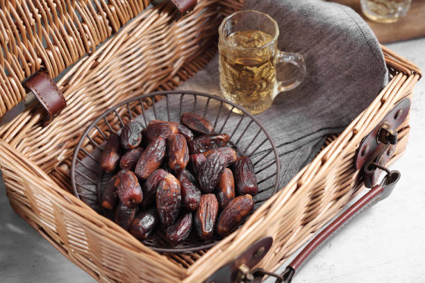 istock dates fruit and Arab tea on a white concrete background with a blank space for a text, dates fruit on a white background 1182412848