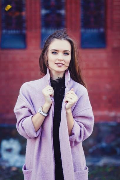 istock girl wearing trench coat. 1182413110