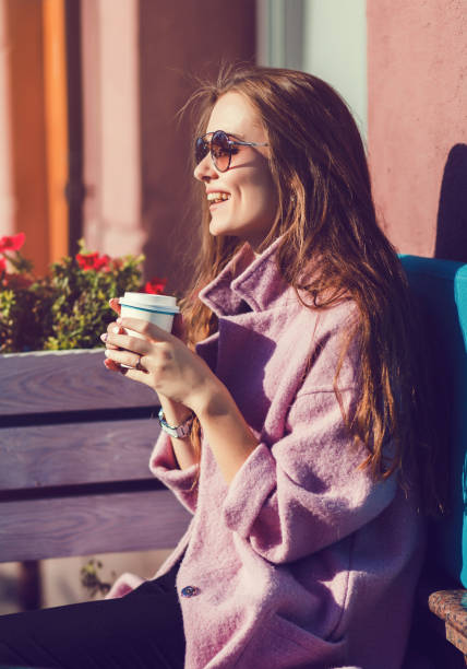 istock Cheerful woman drinking coffee 1182413137