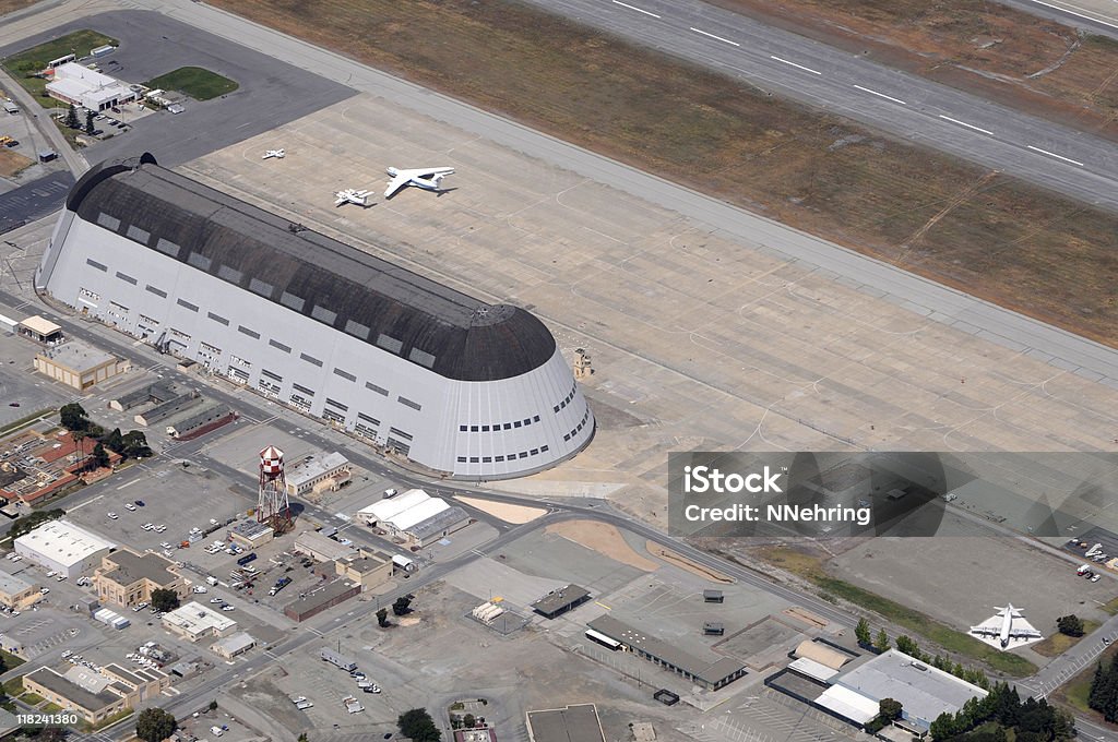 Moffett Field, California, hangar 1 Hanger 1 at Moffett Federal Airfield, Sunnyvale, California, USA. Formerly a naval airstation now operated by NASA Ames. Hanger originally housed Navy dirigible USS Macon and is the largest freestanding structure in the world. NASA research planes on tarmak. The hangar is a Naval Historical Monument. Listed on National Register of Historic Places as Naval Air Station, Sunnyvale, CA, Historic District (Moffett Field) 94000045. Silicon Valley Stock Photo