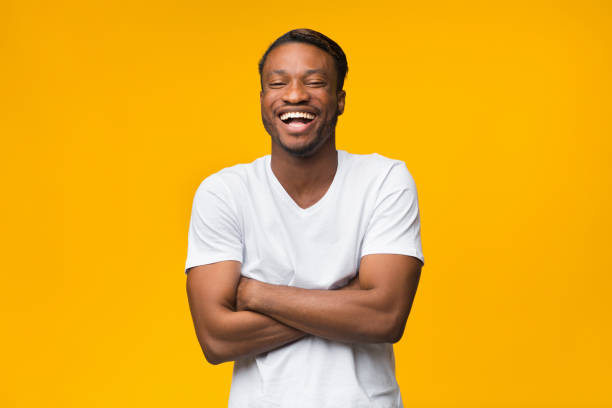 istock Black Man Laughing Crossing Hands Looking At Camera, Studio Shot 1182415487
