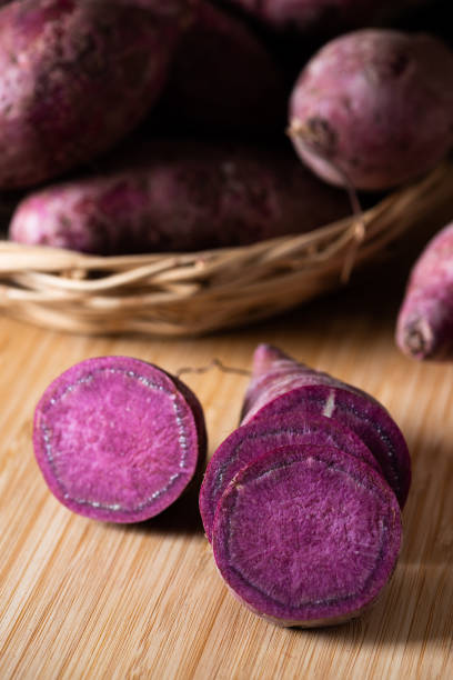 istock Sweet Potatoes Purple Colored on Table 1182416591