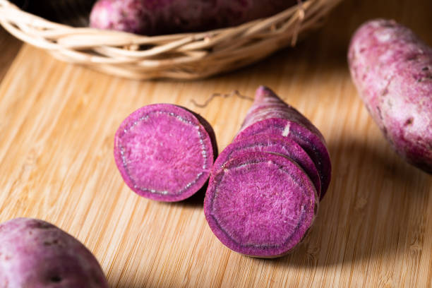 istock Sweet Potatoes Purple Colored on Table 1182416599