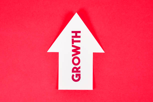 istock White Growth Arrow Symbol Post It Note Paper On Red Background 1182417517