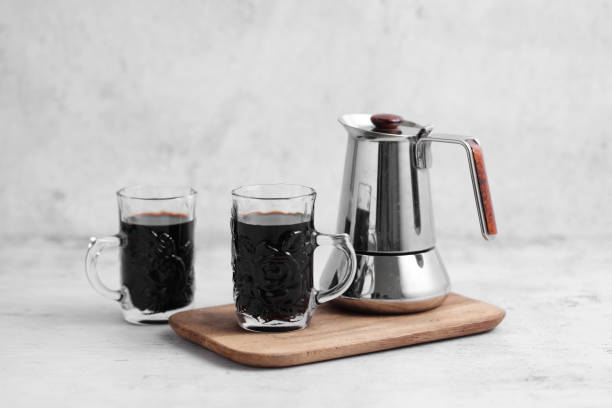 istock Coffee in cup and mocha pot on rustic table with a blank space for a text, Espresso in cup on white background 1182418132