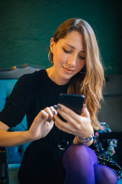 istock Young woman using smartphone at cafe 1182420028