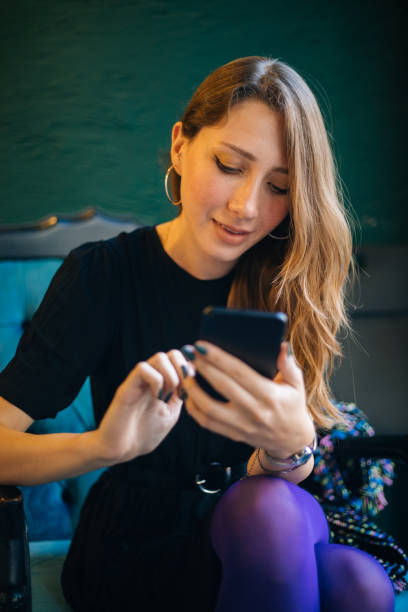 istock Young woman using smartphone at cafe 1182420276
