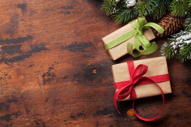 istock Christmas card with gift boxes and fir tree branch 1182420857