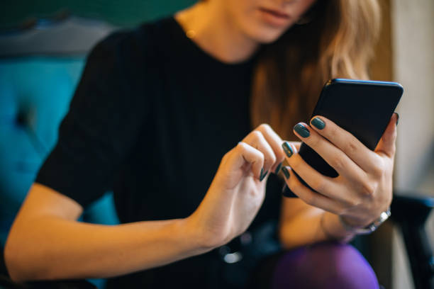 istock Young woman using smartphone at cafe 1182420922