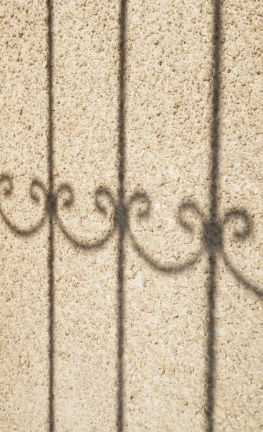 istock shadow of a fence 1182421376
