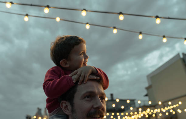 Boy at a party with lights on background