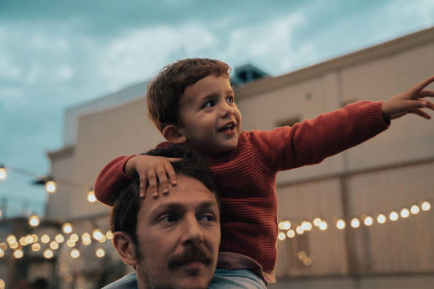 istock Boy at a party with lights on background 1182421952