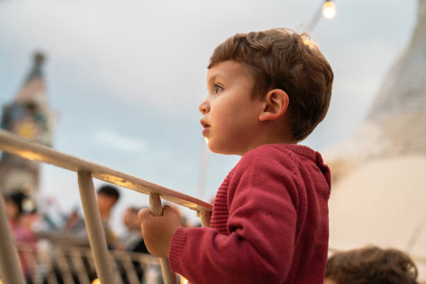 Boy at a party with lights on background
