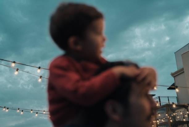 istock Boy at a party with lights on background 1182422015