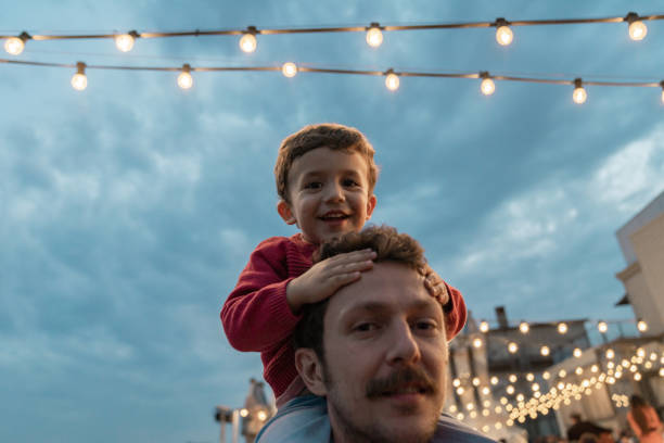 istock Boy at a party with lights on background 1182422035