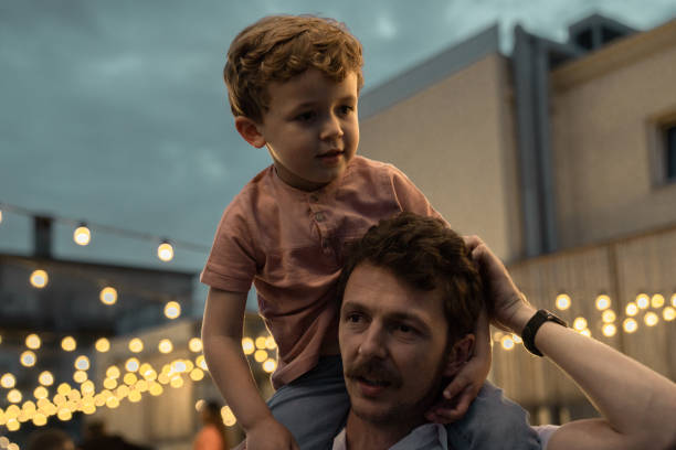 istock Boy at a party with lights on background 1182422090