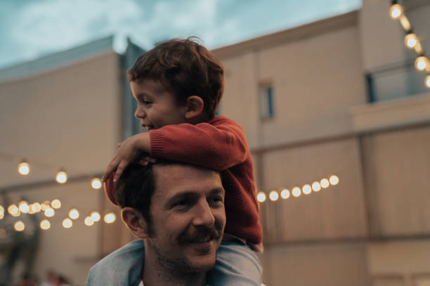 istock Boy at a party with lights on background 1182422603