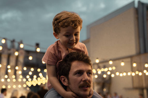 istock Boy at a party with lights on background 1182422620