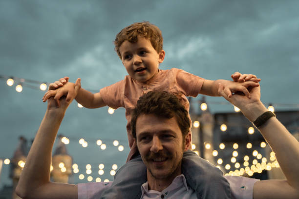istock Boy at a party with lights on background 1182422650