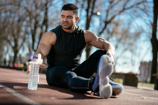 istock Young athlete drinking water after exercising 1182423541