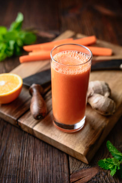 Immunity boosting drink for breakfast, freshly made nutritious carrot, orange and ginger juice stock photo