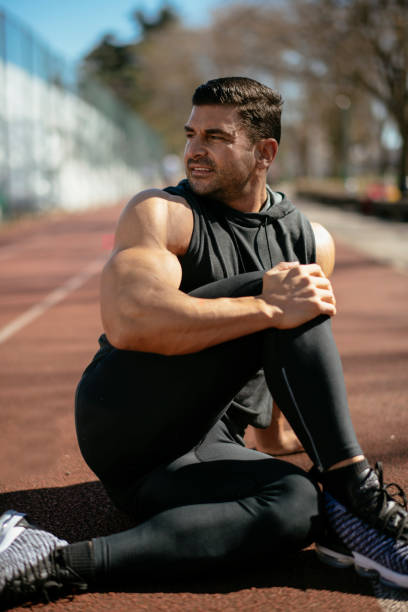 istock Young athlete stretching himself in park 1182423652