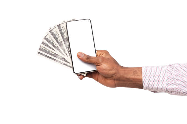 istock Man's hand holding smartphone with blank screen and cash 1182423911