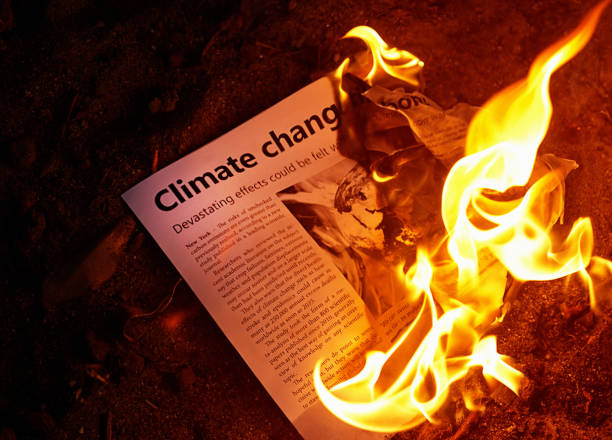 istock Looking down on burning newspaper with headline 