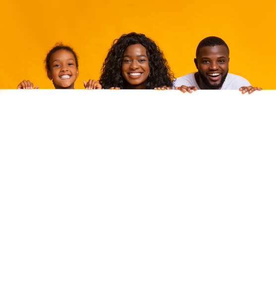 istock Black family leaning on blank white board for advertisement 1182426535