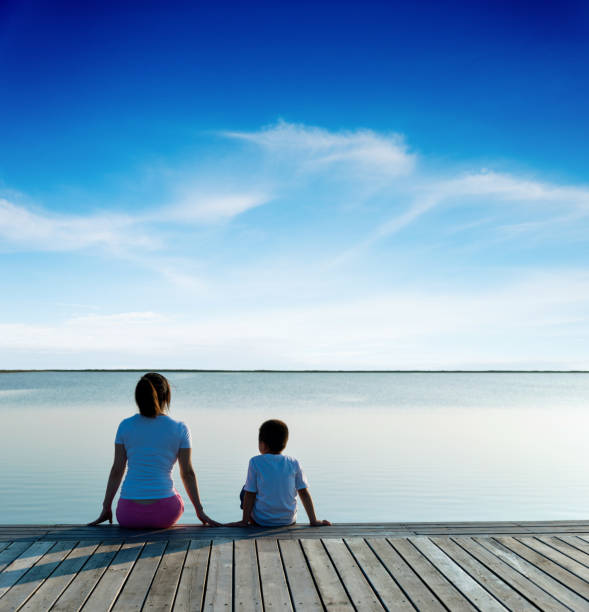 istock Mother with her son enjoying lake view 1182429192