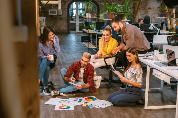 istock Creative people workplace. Young designers working together 1182429983