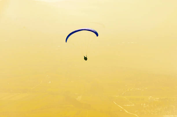 Prilep, Macedonia - 02 Noe, 2017: Paraglider flies on background of sunset sky